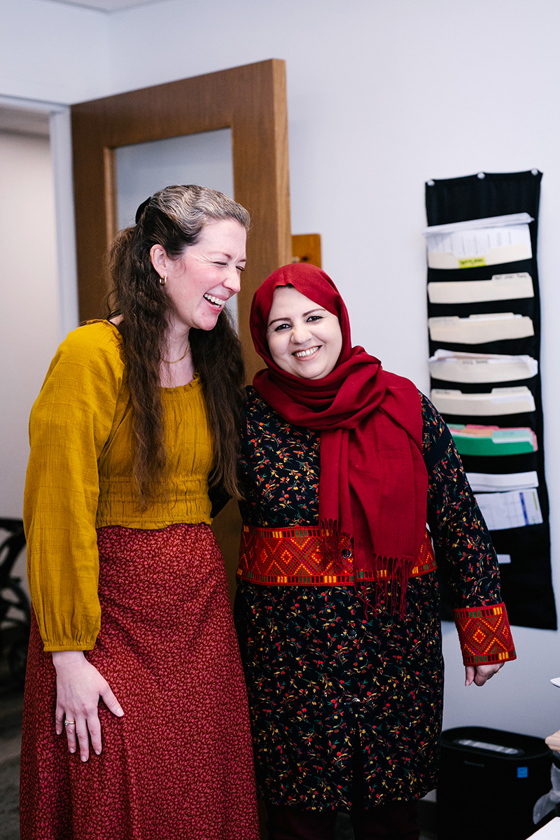 two-women-office-laughing Two women laugh together in an office.